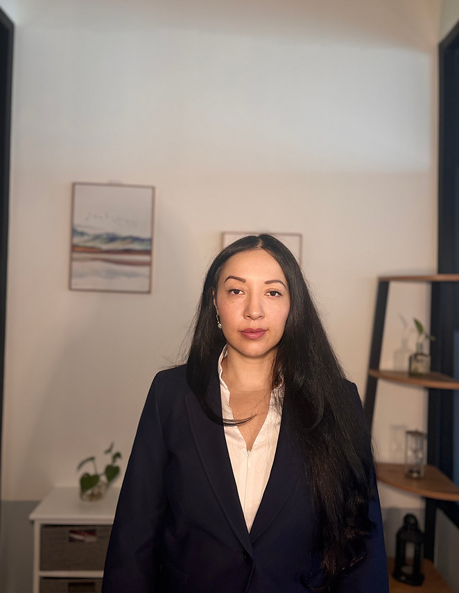 Karina Carlos in a navy suit.